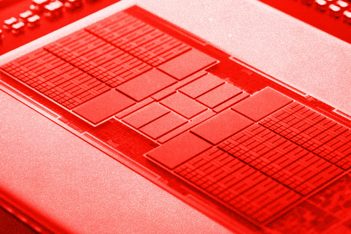 Red-tinted close-up of a processor package showing multiple rectangular chiplet dies