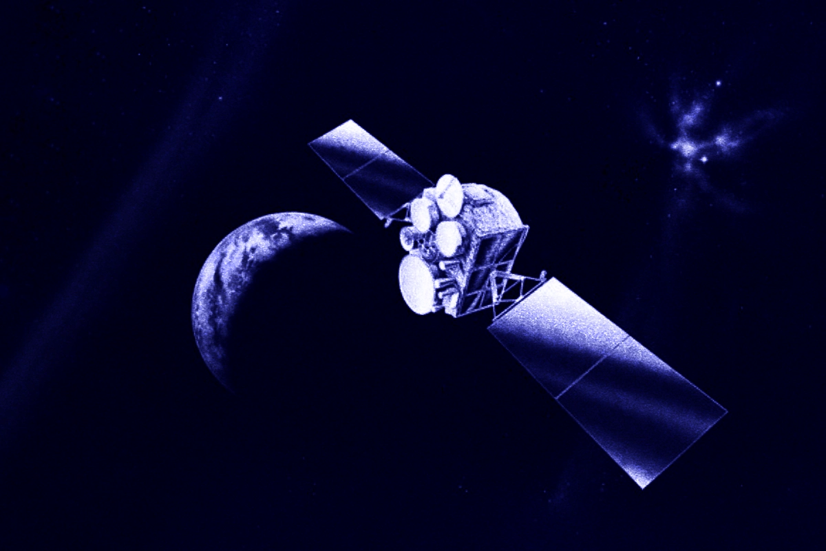 A communications satellite with solar panels orbits above a crescent Earth in dark blue monochrome