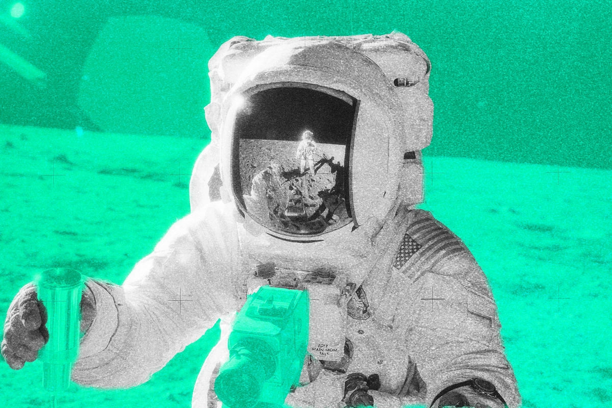 An Apollo astronaut on the lunar surface with another astronaut reflected in the visor, tinted green