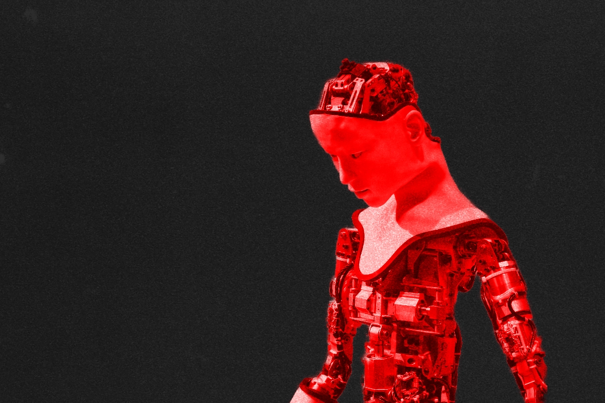 Red-tinted humanoid robot with exposed mechanical skull and torso bowing its head against black