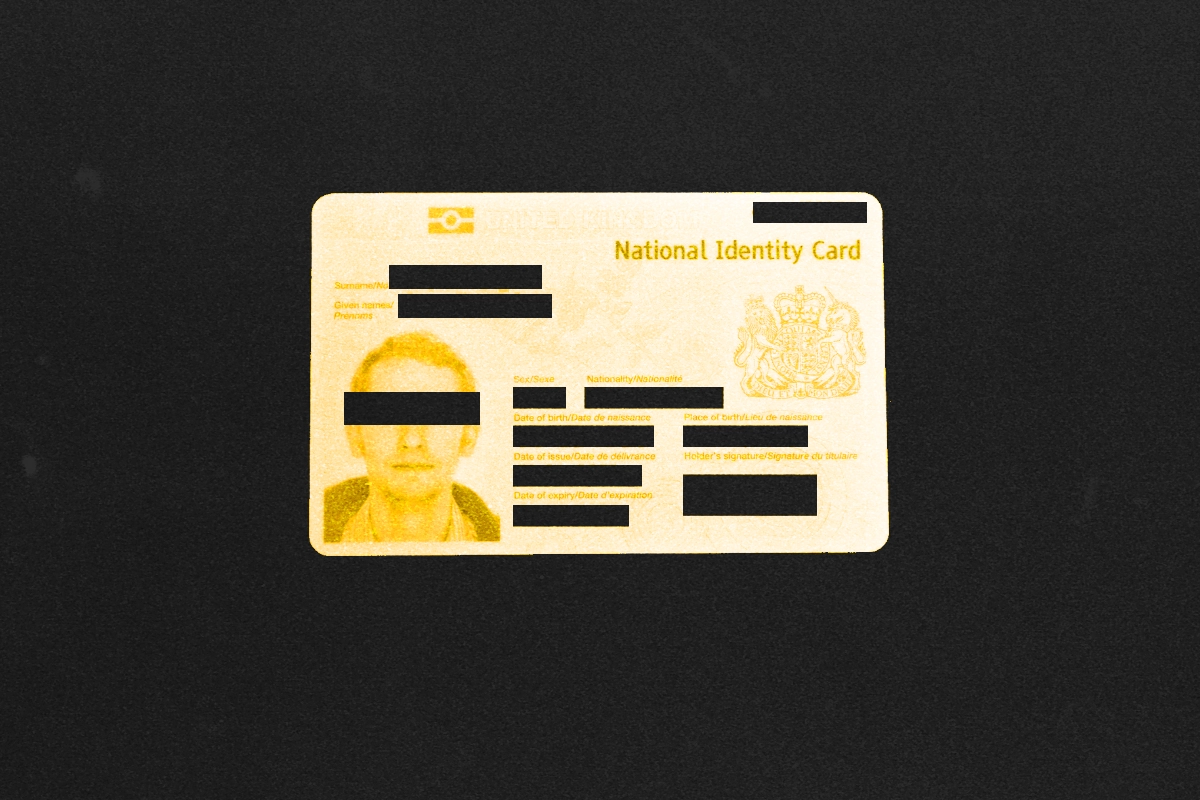 UK "National Identity Card" with the holder's eyes and details blacked out on a dark background